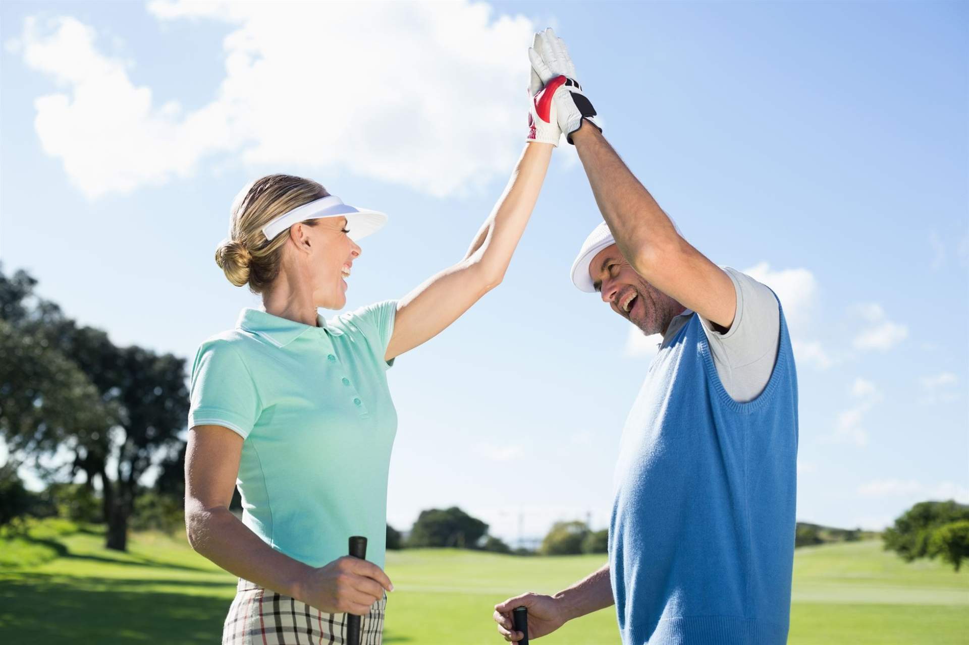 middle aged couple playing golf